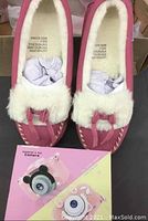 Children's panda design toy camera on colorful card, included in lot, shown alongside moccasins.