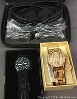 Photo showing two watches: wooden watch in box and Infantry watch with black nylon strap in open box.