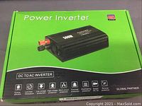 Front of green box showing power inverter image and features like DC to AC conversion, protection types, and energy efficiency icons.