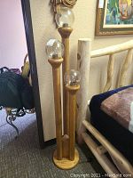 Full view of oak floor lamp with three glass globe shades