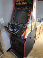 Angled full-view of cabinet showing monitor, control panel and side artwork