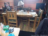 Front view of rustic log dining table with six chairs