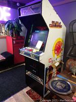 Full view of upright arcade cabinet showing side panel artwork.