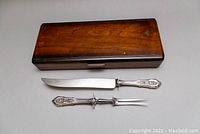 Full set with knife and fork displayed next to closed wooden case