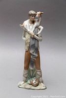 Front view of Lladró porcelain figurine showing boy carrying a lamb on his shoulders
