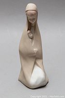 Front view of the Lladró porcelain figurine of a woman holding a child