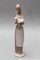 Front view of the Lladro figurine showing the woman holding a lamb.