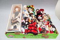 Full lot overview showing all approximately 15 dolls including the boxed Anne of Green Gables doll and assorted other dolls in traditional costumes