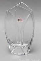 Frontal view of clear crystal vase showing overall sculptural shape and Baccarat sticker on body