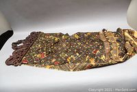 Full view of the Indonesian silk wall hanging, showing the textile and carved wood top piece.