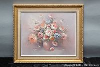 Framed floral oil painting showing overall composition and condition of frame with minor nicks.