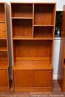 Front view of entire two-piece teak veneer bookcase
