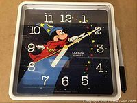Square wall clock with Mickey Mouse Sorcerer's Apprentice design on black face. Clock is working and in like new condition.
