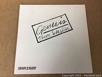 Front cover of Genesis 3 Sides Live double LP gatefold vinyl showing white cover and title