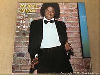 Front cover of the Michael Jackson 'Off the Wall' album showing the artist in a tuxedo against a brick wall background.