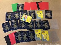 Top-down view of 28 Pokémon card protective sleeves and one sealed holographic Pokémon trading card featuring Pikachu, displayed on a beige surface.