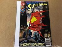 Front cover photo showing Superman #75 comic book with torn cape flag image and The Death of Superman tagline.