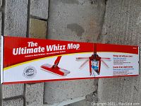 Photo of The Ultimate Whizz Mop in its original box with branding and features visible.