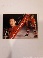 Front of hockey card showing Pierre Pilote in Chicago Blackhawks uniform, with autograph in silver pen.