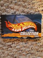 Front cover showing the Hot Wheels 2001 Collection title in flames with a car image on a blue background.
