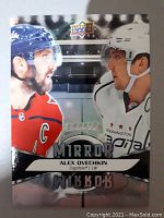 Front of the hockey card featuring Alex Ovechkin in Capitals uniforms with reflective mirror insert design.