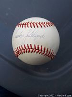 Front view of the baseball showing Carlos Delgado's signature on the sweet spot.