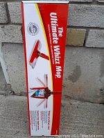 Photo of the unopened box of The Ultimate Whizz Mop with product details printed on the side of the box.