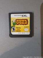Nintendo DS Bookworm game cartridge close-up on a gray surface