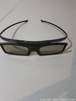 Front view of black Samsung 3D active shutter glasses with rectangular lenses and thin temples.