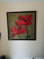 Straight-on view of framed painting showing two red poppies on green background.