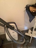 Full view of Sebo Airbelt C3 canister vacuum with attached hose and wand