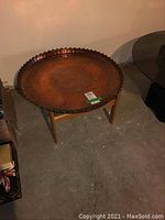 Full view of round table with removable copper tray on wood base