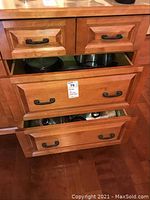 Kitchen wooden drawers with multiple pots and pans inside showing the storage and quantity.