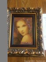 Front view of framed serigraph “Beau Lydia” showing female portrait and ornate frame