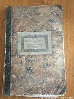 Cover of The Bible Atlas by Samuel Arrowsmith with marbled design, paper label, and worn black spine.