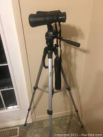 Binoculars mounted on extended tripod, full view