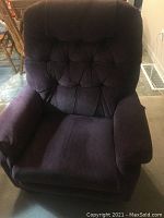 Front view of the La-Z-Boy reclining chair showing the tufted back, seat cushion, and padded armrests in dark pink upholstery.