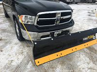 Front view of plow blade mounted on truck front hitch