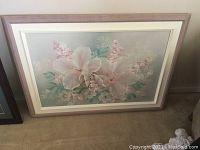 Floral print featuring large white and pink flowers in light wood frame.