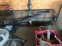 Metal mesh cargo basket and hitch extension bar on floor