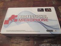 Closed box labeled 'Professional Microphone' with branding and promotional text for professional performance, stability, and easy operation.