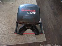 Top view of the black and red padded bench with 'Bowflex UpperCut' embossed on seat