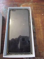 Front view of smartphone in white box showing black screen and notch camera