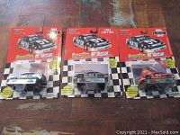 Front view of three Nascar stock car models in original packaging, with visible driver names and numbers