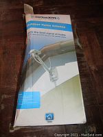 Packaging box of SiriusXM outdoor home antenna showing branding and mounting illustration.