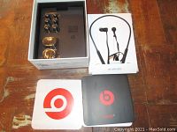 Unboxed earphones with eartips and original packaging including manual and outer boxes, showing all accessories and condition.