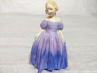 Front view of the Royal Doulton Marie figurine showing the detailed face and colored dress.