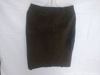 Front view of green suede skirt showing knee-length silhouette and fitted waist.