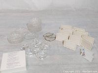 All items together showing name cardholders, coasters, and napkin rings with some wear