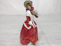 Full side profile of the Royal Doulton Christmas Morn figurine showing detailed paintwork and sculpting.